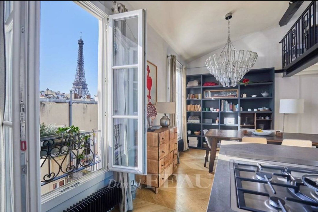 Bright double-exposure living room of the Eiffel View Penthouse with designer furnishings and Paris views